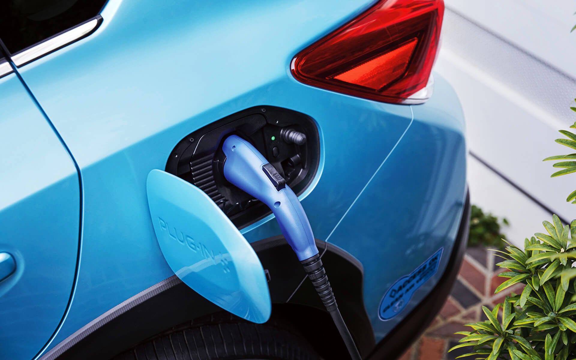 A close-up of the Subaru Crosstrek Hybrid's charging port with charging cable plugged in | Island Subaru in Staten Island NY